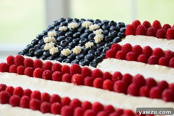 Close-up of a slice of Homemade Flag Cake showing layers of cake and frosting
