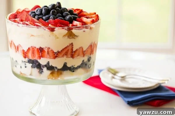 Red, White & Blue Berry Trifle - A festive and easy dessert with layers of angel food cake, fresh strawberries, and blueberries, perfect for summer celebrations by Brown Eyed Baker