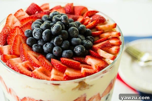 Close-up of the assembled Berry Trifle, showing vibrant layers of berries and cream, ready to be served