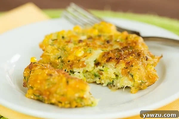 Stack of crispy Zucchini-Corn Fritters on a plate, ready to be served.
