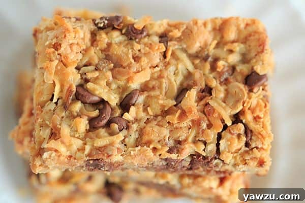A freshly baked pan of Seven Layer Bars cooling on a wire rack, ready to be cut into individual servings.