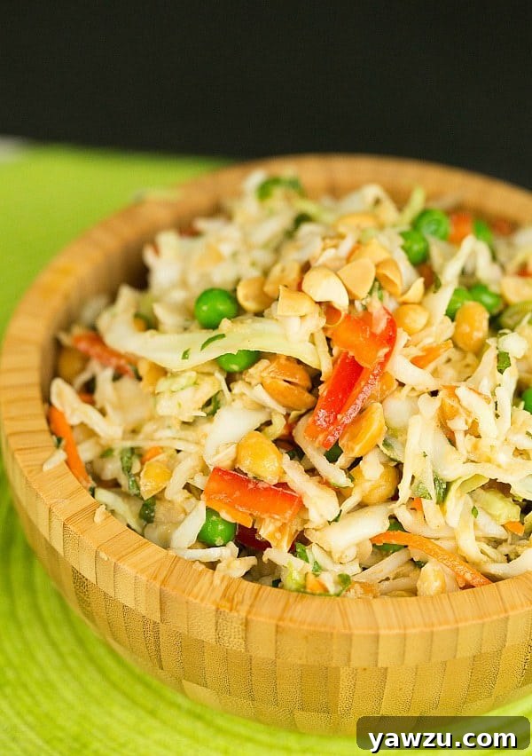 Vibrant Thai Peanut Cabbage Slaw with crispy peanuts and fresh herbs, ready to be served
