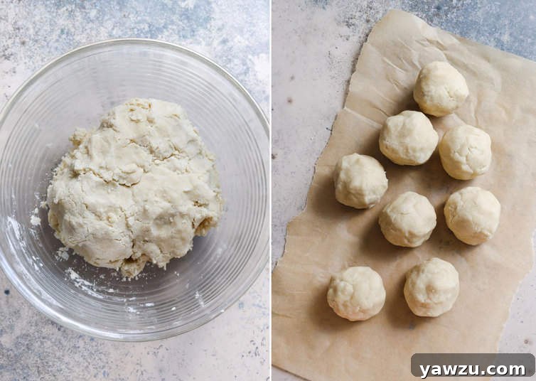 Eight portions of pastry dough, neatly rolled into balls and arranged on a counter, ready for use.
