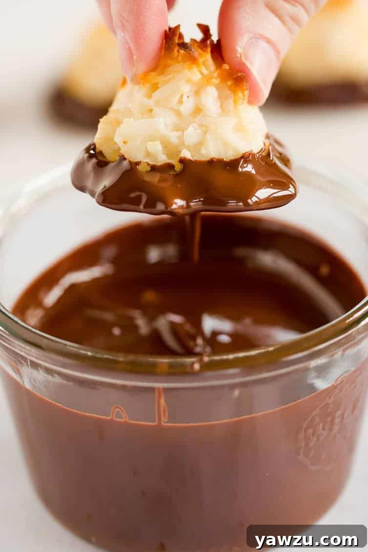 Close-up of golden brown coconut macaroons with a visible chewy texture and slight crisp edges.