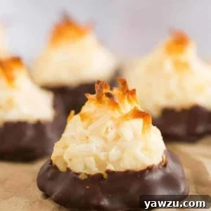 Finished chocolate-dipped coconut macaroons on a tray, ready to be served.