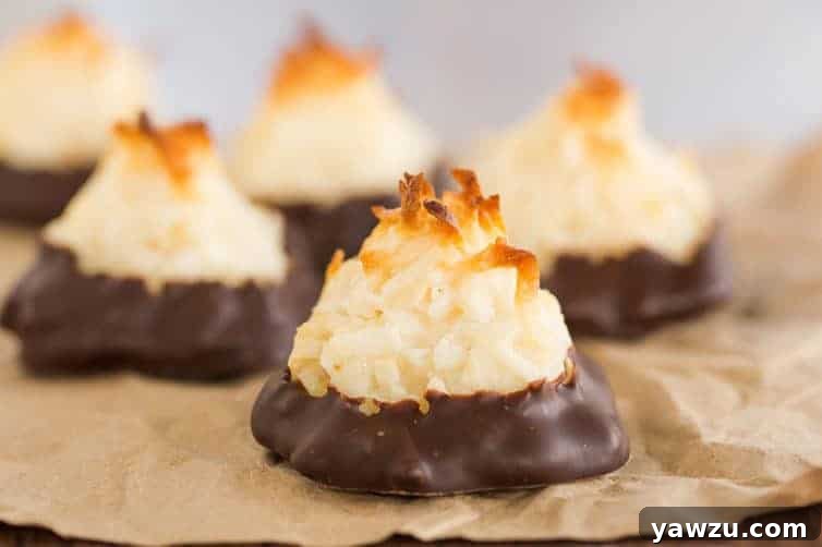 Assortment of chocolate-dipped and plain coconut macaroons, showcasing their beautiful golden texture.