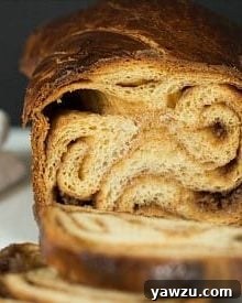 Freshly baked Cinnamon Babka Bread, golden brown with a beautiful swirl.