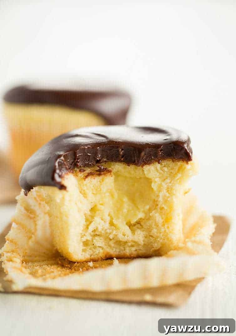 Delicious Boston Cream Cupcakes on a serving plate, inviting a bite, perfect for any sweet craving.