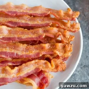 A plate with slices of oven baked bacon.