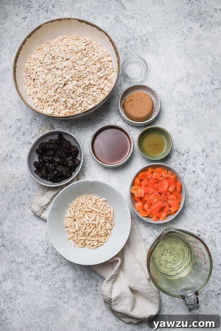 A collection of granola ingredients, including oats, nuts, and sweeteners, neatly prepped in various bowls on a pristine kitchen counter.
