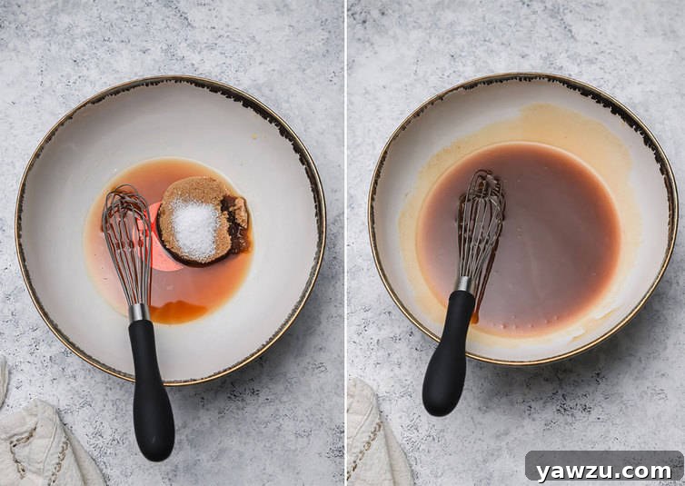 Close-up of wet ingredients being whisked together in a clear mixing bowl, showing the smooth, golden liquid mixture.