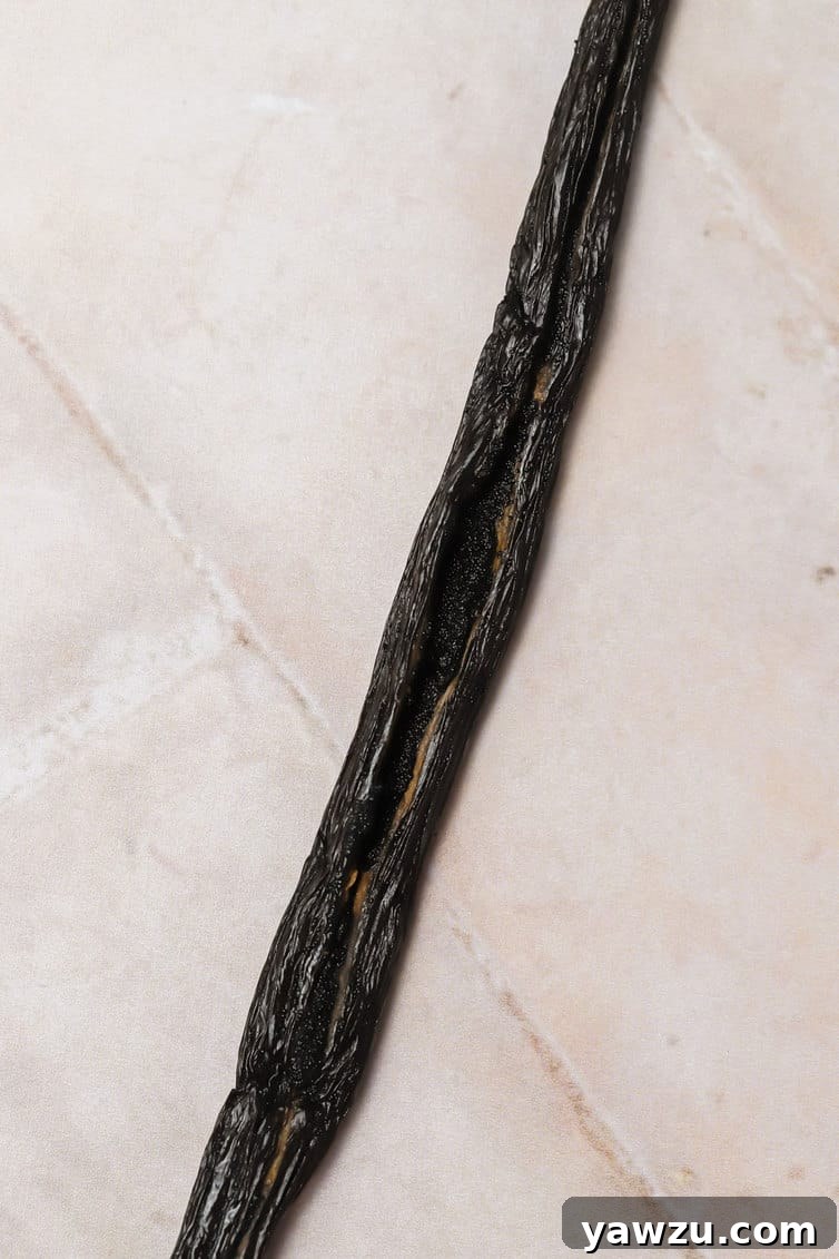 A single vanilla bean split down the center.