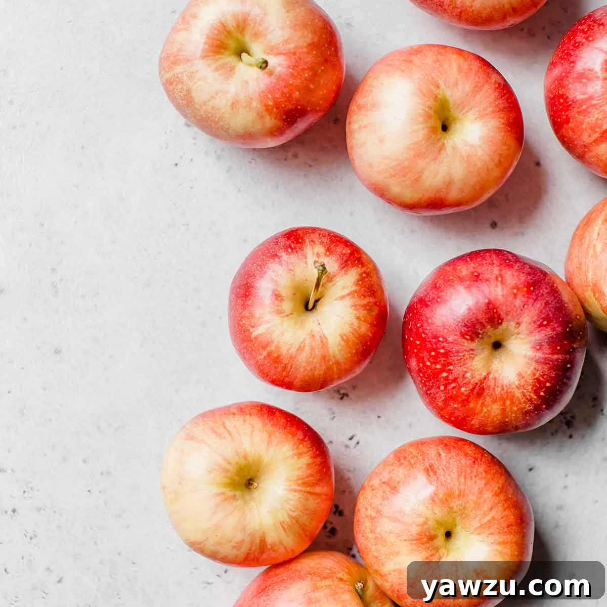 Red apples on a white countertop.