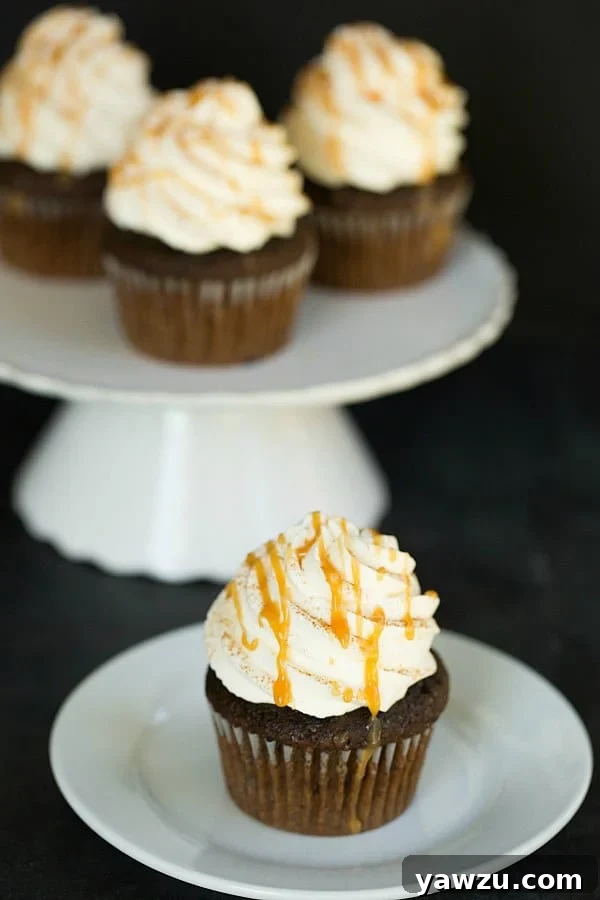 Freshly baked Pumpkin Spice Latte Cupcakes cooling on a wire rack, ready for frosting.