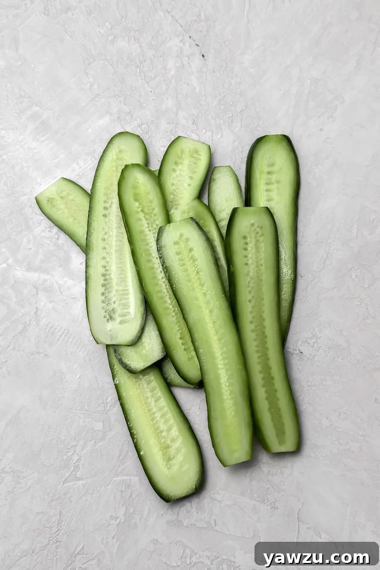 Pickling cucumbers sliced lengthwise.