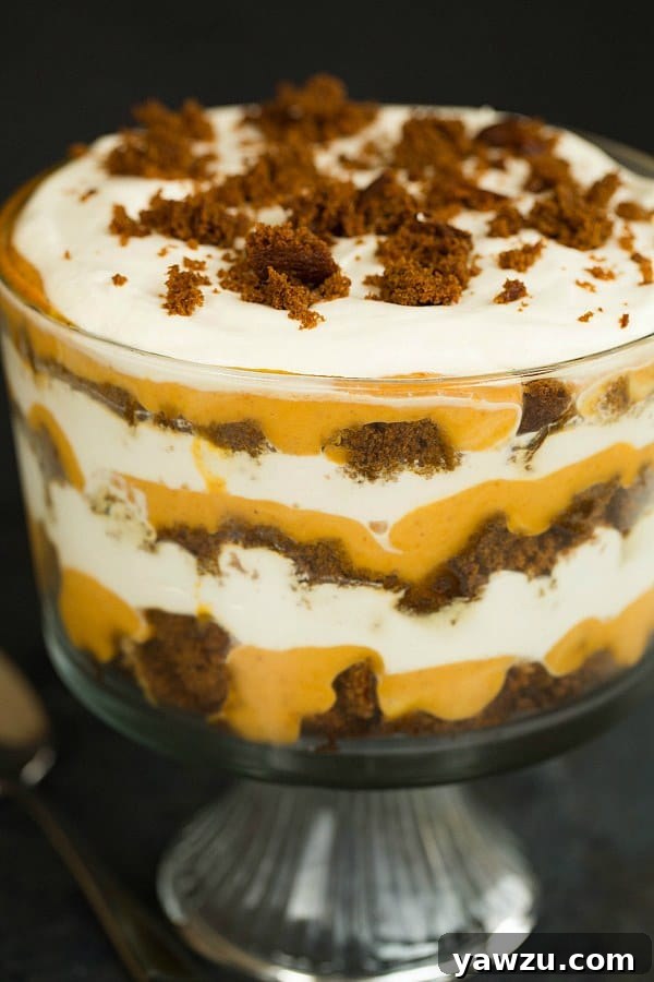 Delicious Pumpkin-Gingerbread Trifle layers in a clear glass bowl, perfect for holiday gatherings