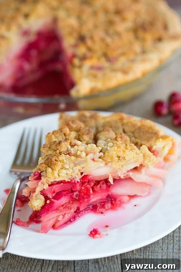 Cranberry-Ginger Pear Pie adorned with a beautiful lattice crust and vibrant filling, ready for holiday celebrations.
