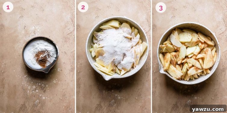 Sliced apples tossed with lemon juice and spices, ready for pie assembly.