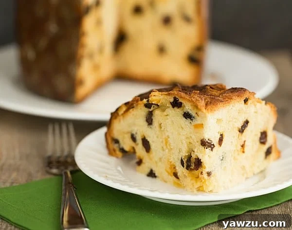 Sliced Panettone ready to be served, revealing its light, fluffy texture and generous candied fruit distribution, perfect for holiday indulgence.