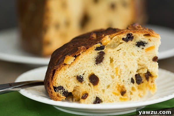 A whole Panettone loaf, perfectly golden and inviting, ready to become the centerpiece of any Christmas table, showcasing the beauty of homemade Italian Christmas bread.