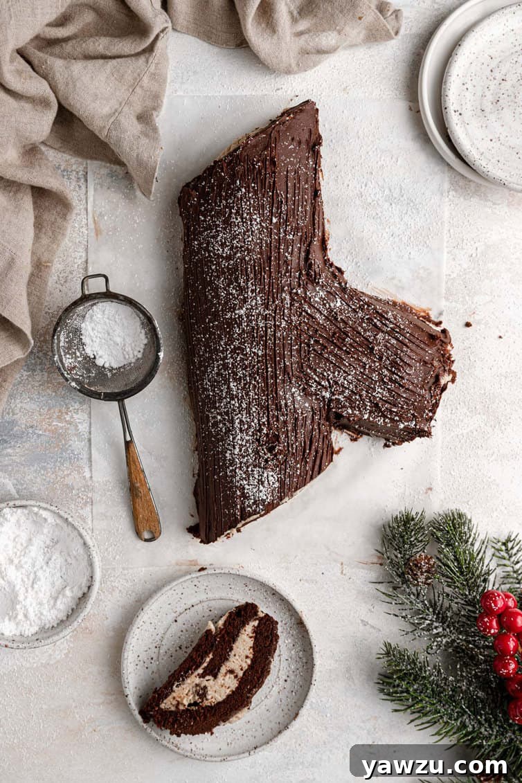 Overhead photo of Buche de Noel with a slice on a plate next to it.