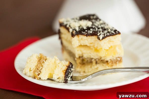 Hand carefully placing a piece of Decker Cake onto a serving platter alongside other holiday treats