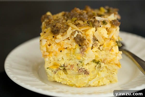 Layers of savory sausage, crispy hash browns, and melted cheddar in an easy overnight breakfast casserole.
