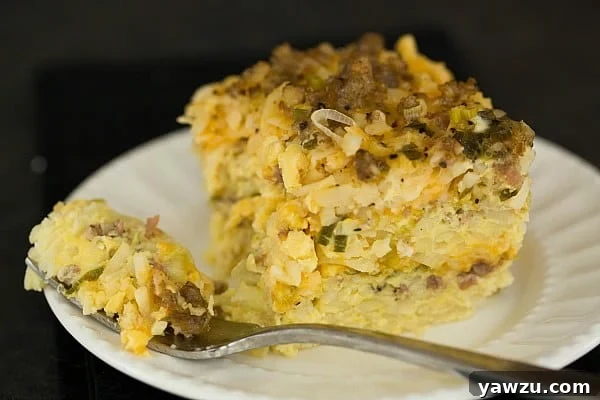 Golden brown Slow Cooker Sausage, Hash Brown & Cheddar Breakfast Casserole, ready to serve.