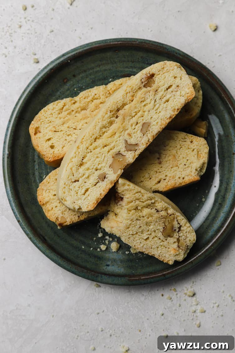 Butternut Walnut Biscotti, perfectly stacked on a dark plate, inviting a delicious bite.