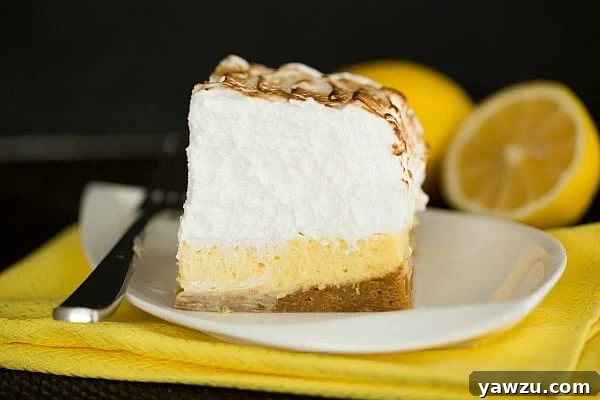 Sky-High Lemon Meringue Bars: A delightful dessert with a graham cracker crust, tangy lemon filling, and towering toasted meringue.