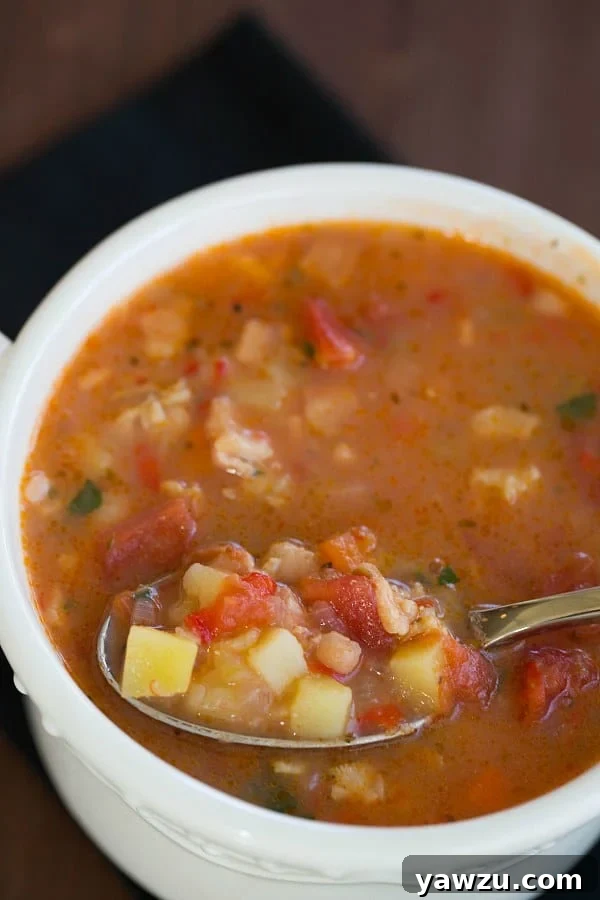 Manhattan Clam Chowder served in a bowl with fresh herbs