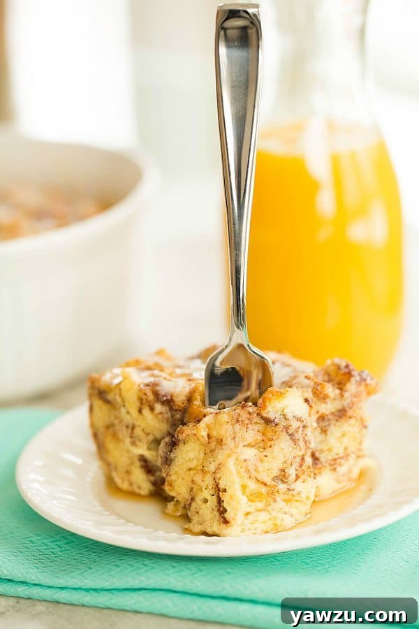 Freshly baked Cinnamon Roll Bread Pudding, topped with a creamy white icing drizzle, cooling on a wire rack.