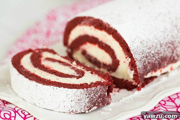 Close-up of a Slice of Red Velvet Roll Cake Revealing the Moist Cake and Creamy Filling
