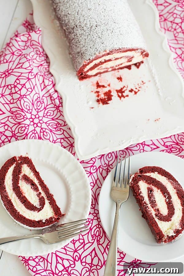 Finished Red Velvet Roll Cake Dusted with Powdered Sugar on a Serving Platter