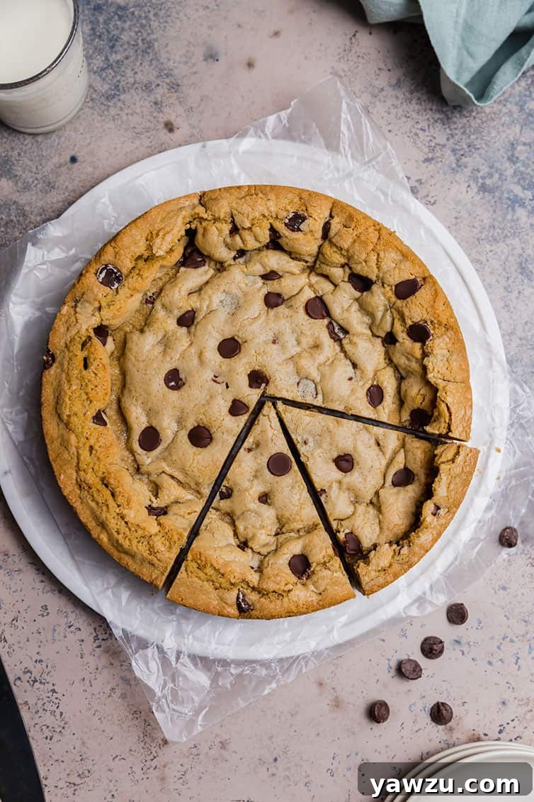 Overhead photo of chocolate chip cookie cake with two slices cut.