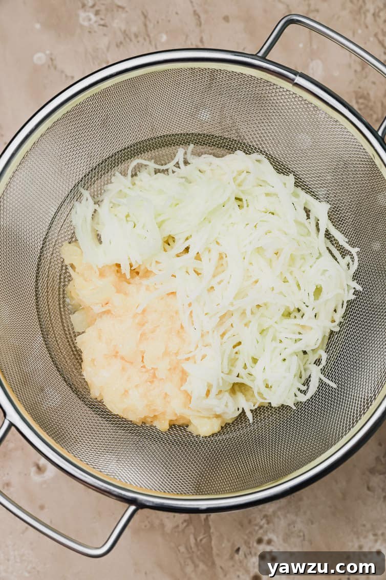 Shredded apple and crushed pineapple in a colander, illustrating the important step of draining excess liquid for perfect muffin texture and preventing sogginess.