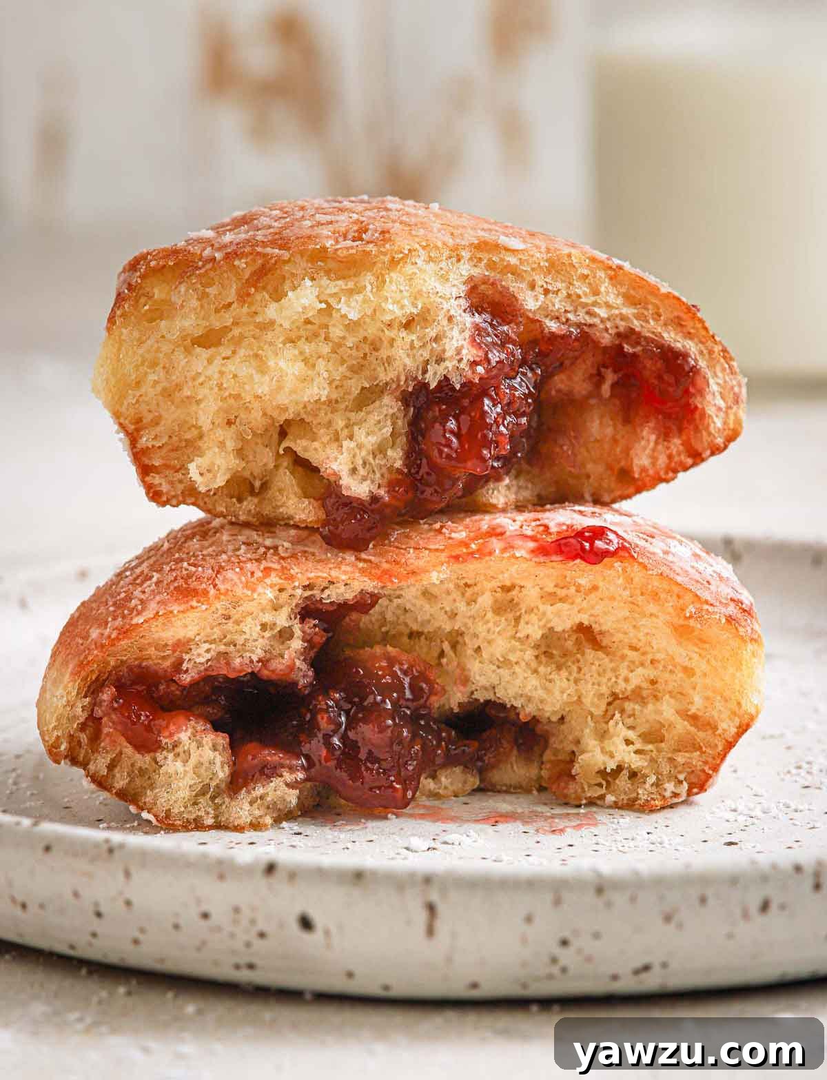 Paczki doughnut broken in half and stacked on top of each other.