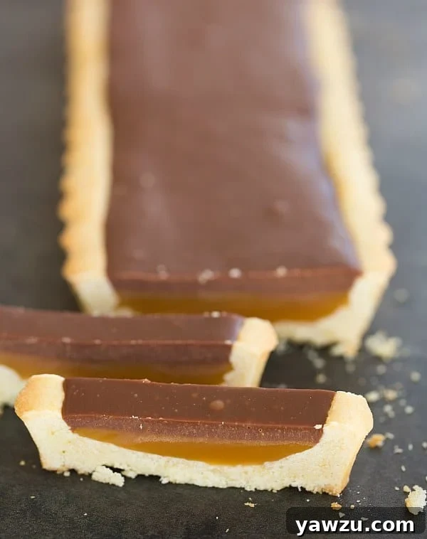 Delicious Twix Candy Bar Tart with Shortbread Crust, Caramel, and Milk Chocolate Ganache