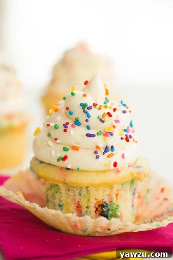 Funfetti cupcakes cooling on a wire rack, ready for frosting