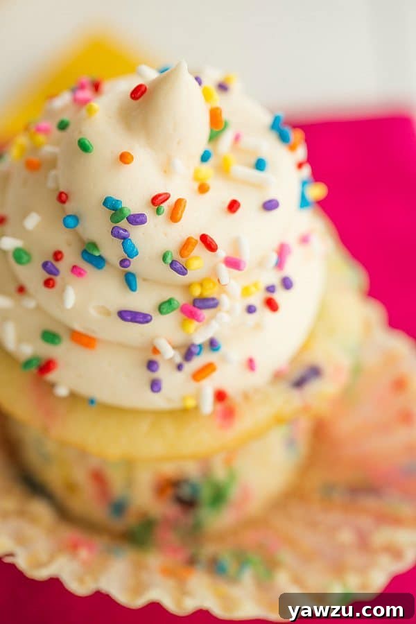 Freshly frosted Funfetti cupcakes with generous vanilla buttercream and sprinkles
