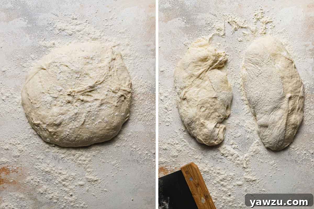 Ciabatta bread dough turned out onto a floured surface, then meticulously divided in two using a bench scraper.