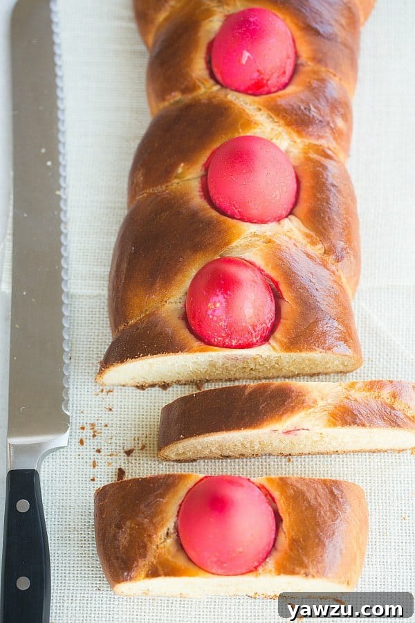 Greek Easter Bread [Tsoureki] - A beautiful braided sweet bread with red dyed eggs, perfect for Easter celebrations. Find the recipe on browneyedbaker.com.