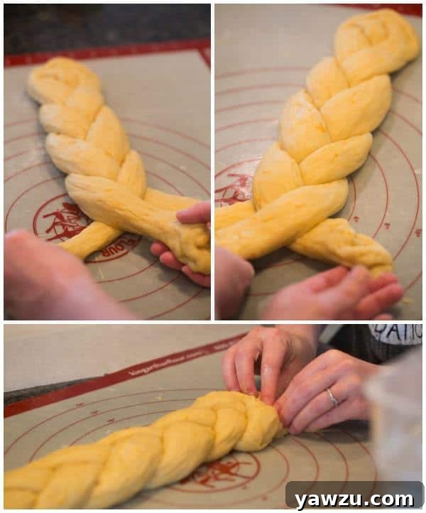 Greek Easter Bread [Tsoureki] - Two braided loaves of sweet Tsoureki bread, adorned with vibrant red Easter eggs. A symbol of spring and rebirth.