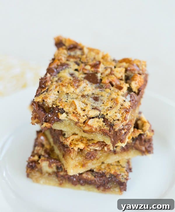 Close-up of Chocolate Chip-Pecan Pie Bars cooling on a wire rack, showing gooey filling