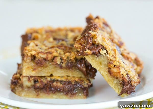 Neatly sliced Chocolate Chip-Pecan Pie Bars with a rich, dark filling and visible nuts
