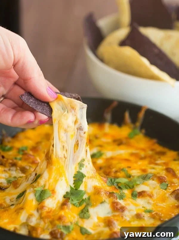 Queso Fundido with spicy chorizo and melted cheese, perfect for dipping.