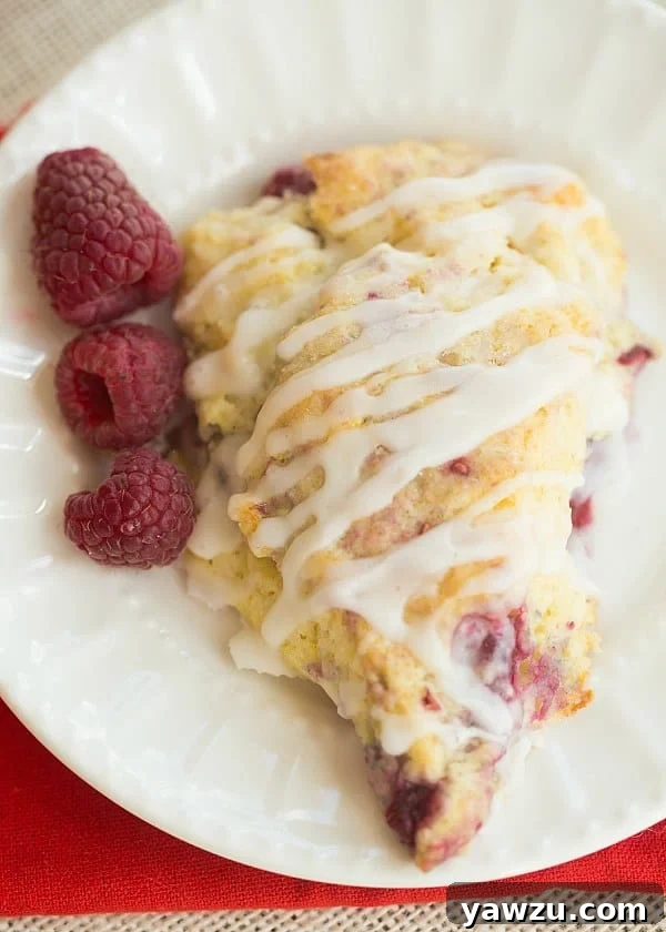 Delightful Meyer Lemon-Raspberry Scones with a sweet glaze, perfect for spring breakfasts or Mother's Day brunch.