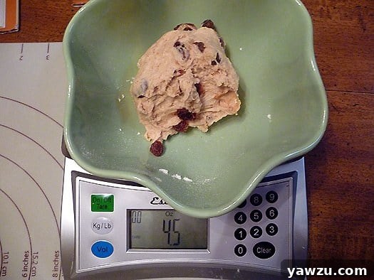 Green bowl with a scoop of ice cream in it on a food scale.