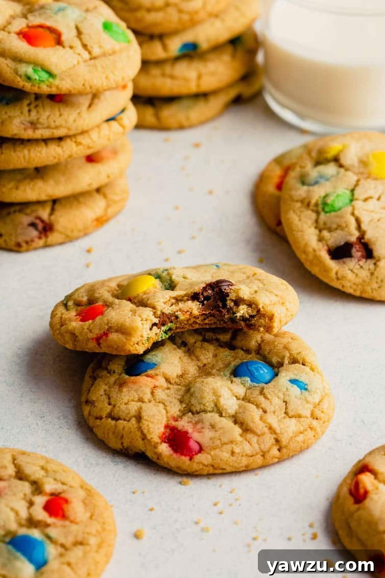 A delicious M&M cookie with a bite taken out, showcasing its soft, chewy interior and colorful candies.