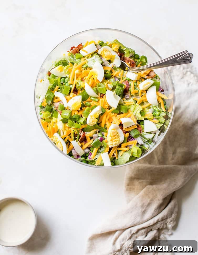 An overhead shot of a trifle bowl full of seven layer salad.